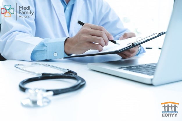 doctor-working-with-laptop-computer-writing-paperwork-hospital-background_1421-69